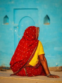Unidentified Indian rural woman in traditional sari shot from behind