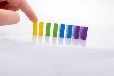 Colorful Domino Blocks in a line on a white background