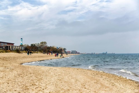 Strollers on the south beach in autumn