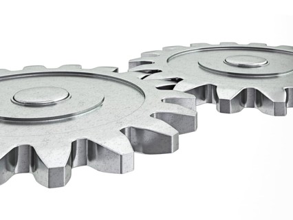 Teamwork success cooperation partnership concept: gear cogwheels working together isolated on white