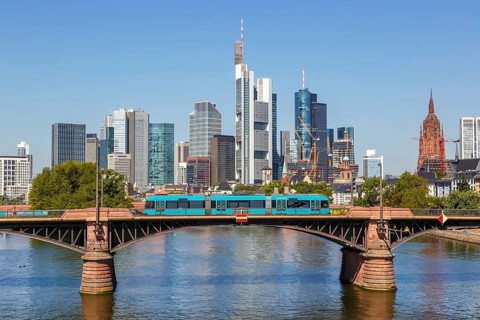Skyline with river Main and light rail on Ignatz Bubis bridge Travel in Frankfurt
