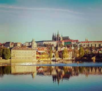 Vintage retro hipster style travel image of Mala Strana and Prague castle over Vltava river. Prague