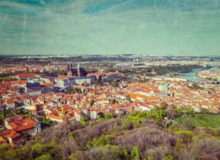Vintage retro hipster style image of aerial view of Hradchany the Saint Vitus Cathedral and Prague Castle from Petrin Observation Tower with grunge texture overlaid. Prague