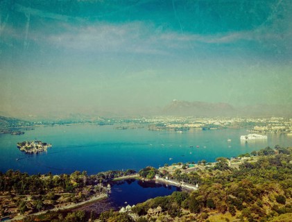 Vintage retro hipster style travel image of aerial view of Lake Pichola with Lake Palace