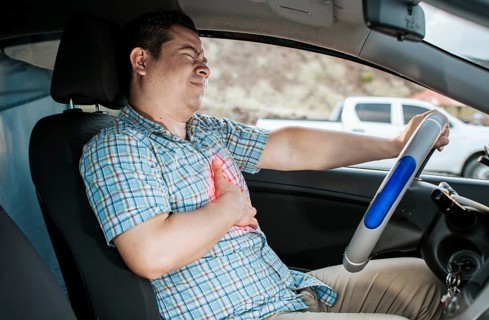Suffering driver with chest pain. Male driver with chest pain in traffic. Person with heart attack while driving. Driver with chest pain. Driver's Heart Attack Concept