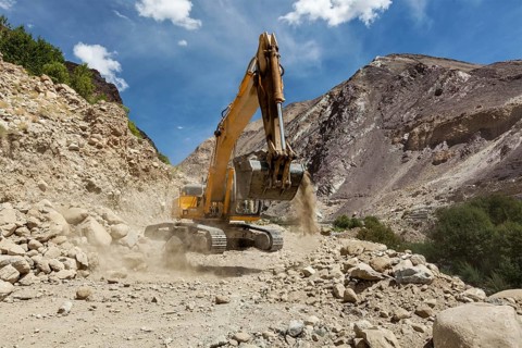 Excavator doing road construction in Himalayas. Ladakh