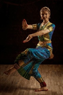 Vintage retro style image of young beautiful woman dancer exponent of Indian classical dance Bharatanatyam in Shiva pose