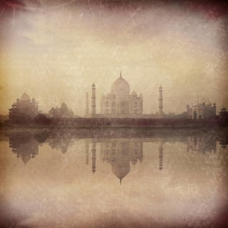Vintage retro hipster style image of Taj Mahal on sunrise sunset reflection in Yamuna river panorama in fog