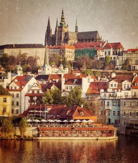 Vintage retro hipster style travel image of Mala Strana and Prague castle over Vltava river with grunge texture overlaid. Prague