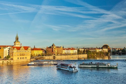 Vltava river with tourist boats and Prague Stare Mesto embankment view from Charles bridge on sunset. Prague