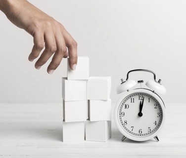 Hand putting white cubes clock