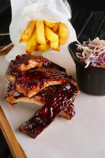 Grilled ribs served with fried potato and red cabbage