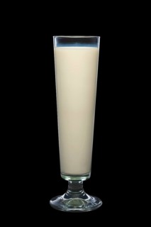 Tall glass of milk isolated on black background