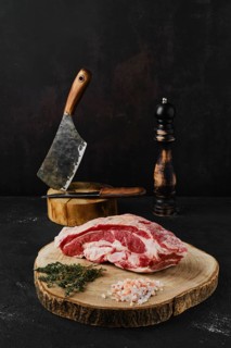 Raw beef brisket on wooden cutting board