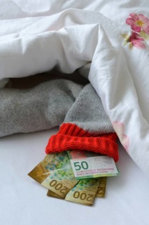 Banknotes in stocking under duvet