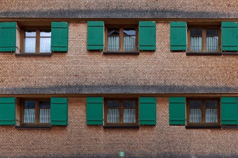 Allgaeu house with shingle facade and shutters