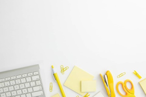 Flat lay stationary arrangement desk with yellow supplies