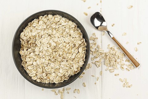 Oatmeal bowl with spoon on the table