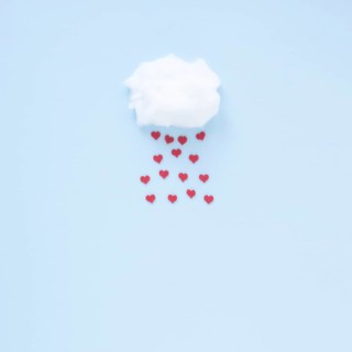 Red hearts falling from cloud