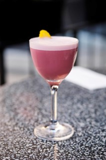 Cherry brandy cocktail on the table on outdoor terrace