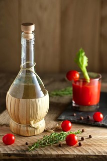 Rustic cocktail Bloody Mary with ingredient on wooden table