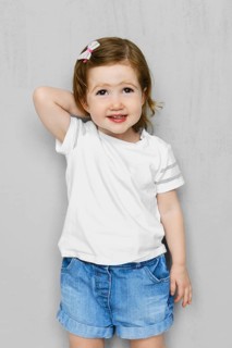 Two years old girl in white t-short and jeans shorts posing in studio
