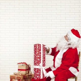 Santa claus putting presents bag