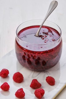 Close up view of transparent pot with raspberry jam