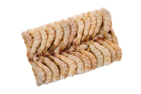 Overhead view of raw tiger shrimp frozen in large ice cube isolated on white background