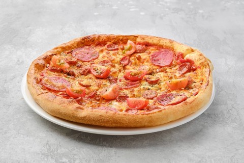 Pizza pepperoni with two kind of sausages on a plate