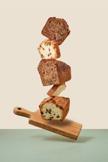 Stacked pieces of biscuit cupcakes. Balancing cakes on wooden board