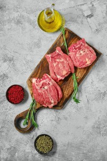Top view of raw lamb neck meat on cutting board