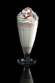 Milkshake caramel summer cocktail isolated on black
