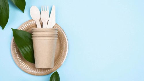 Disposable plates with cups cutlery blue copy space background