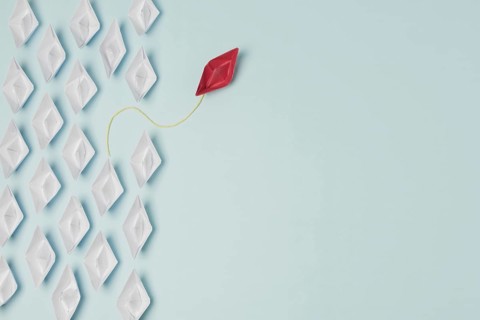 Origami boats leadership concept