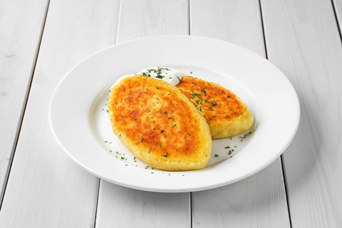Traditional belarussian potato cakes with sour cream