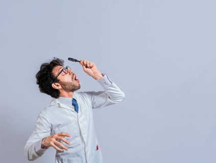 Surprised man in lab coat with magnifying glass looking at an advertisement above. Scientist man looking up with a magnifying glass. Amazed man observing an advertisement with a magnifying glass