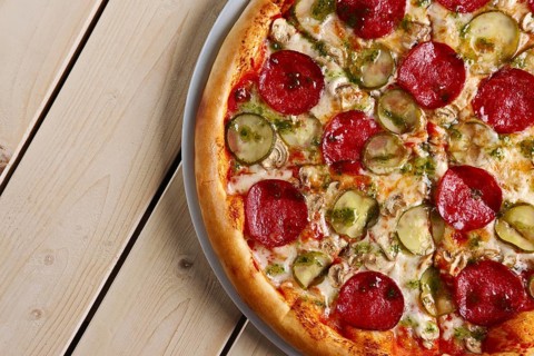Top view of piece of pizza with sausage