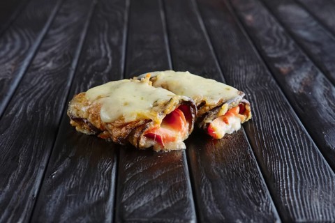 Appetizer for reception. Eggplant stuffed with bacon