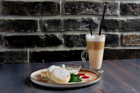 Traditional breakfast with cottage cheese pancake with sour cream