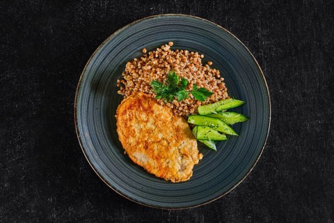 Chicken fillet fried in batter with buckwheat porridge and pickled cucumber