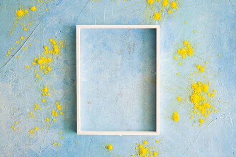 Yellow color powder around the white border frame on painted wall. Resolution and high quality beautiful photo