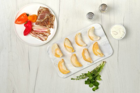 Top view of frozen dumplings with bacon and mashed potato