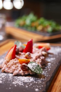 Sweet oatmeal with fruits decorated with sugar powder. Photo taken with shallow depth of field