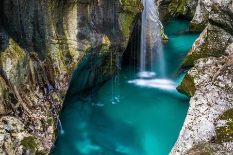 Mountain river Soca flows through narrow canyon