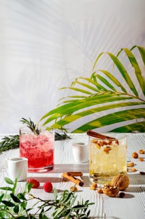 Refreshing espresso and tonic summer drinks on white table under hard sulight