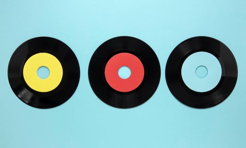 Flat lay old disc records blue background