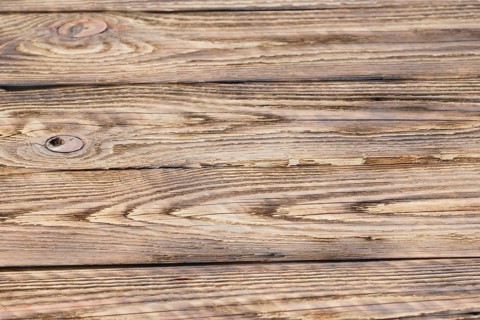 Soft focus photo of old partly burned wooden background