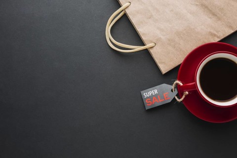Discount paper bag with coffee flat lay