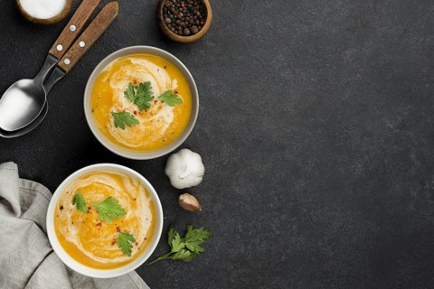 Flat lay delicious autumn soup composition with copy space